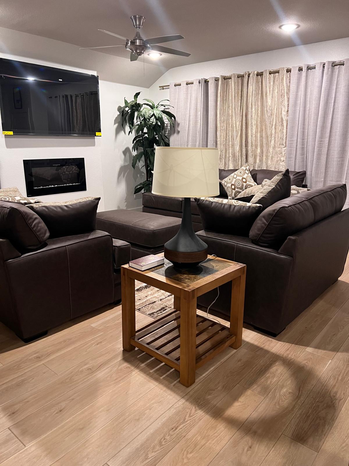 Living room at The Valley of Eshcol with comfortable sofas and a warm fireplace